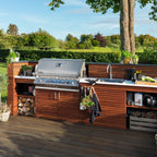 Napoleon Prestige PRO 665 Built-In in a wooden outdoor kitchen on a sunny deck