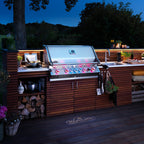 Napoleon Prestige PRO 665 Built-In at dusk with its control knobs glowing