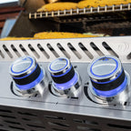 Lit control knobs on the Napoleon Prestige PRO 665 Built-In with food on the grill