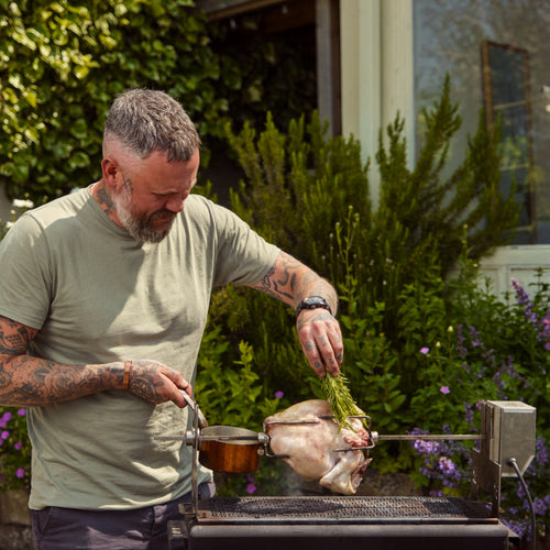 Roasting chicken on the Blok rotisserie in a garden