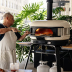 Chef cooking with the Gozney Dome XL (Gen 2) in Bone on a city terrace