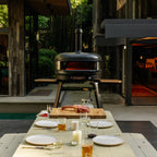 Gozney Dome XL (Gen 2) in Off Black at the head of an outdoor dinner table