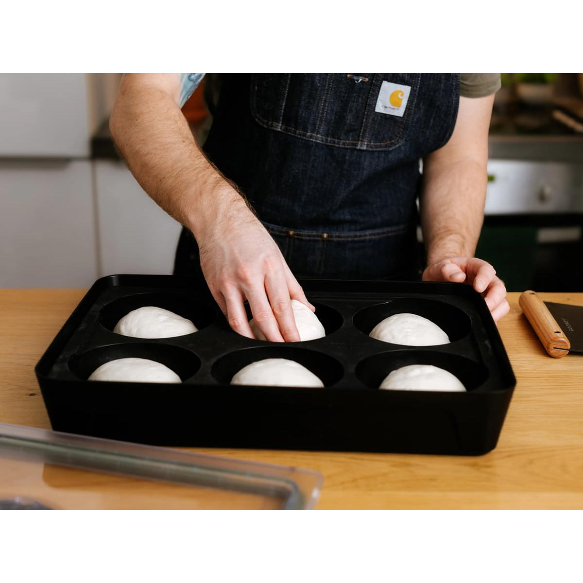 Dough balls being placed in the Gozney Dough Tray