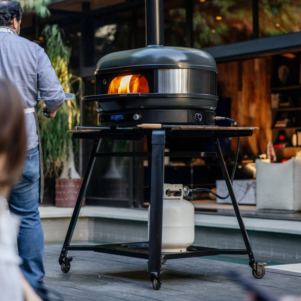 Gozney Dome (Gen 2) Stand with a Dome oven in use by a pool