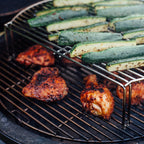 Chicken and courgettes cooking on two levels with the Kamado Joe grill expander
