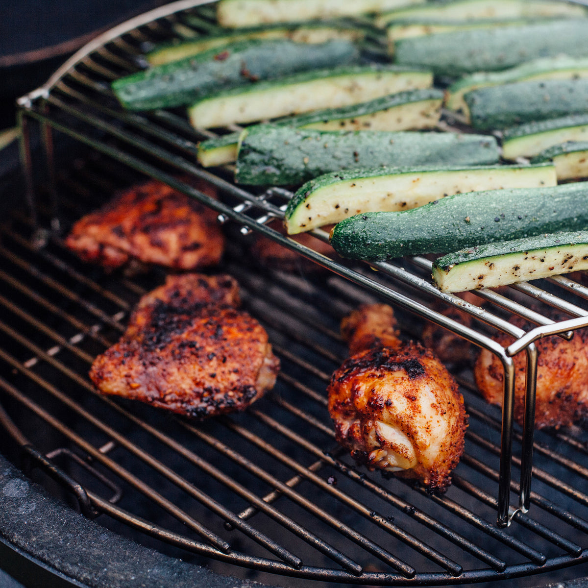 Chicken and courgettes cooking on two levels with the Kamado Joe grill expander