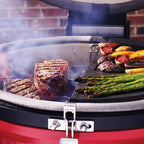Steak and asparagus on the Kamado Joe grill expander in a Classic Joe