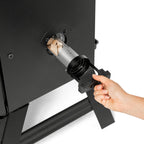 Loading wood chips into the side loader of the Masterbuilt 710 WiFi smoker