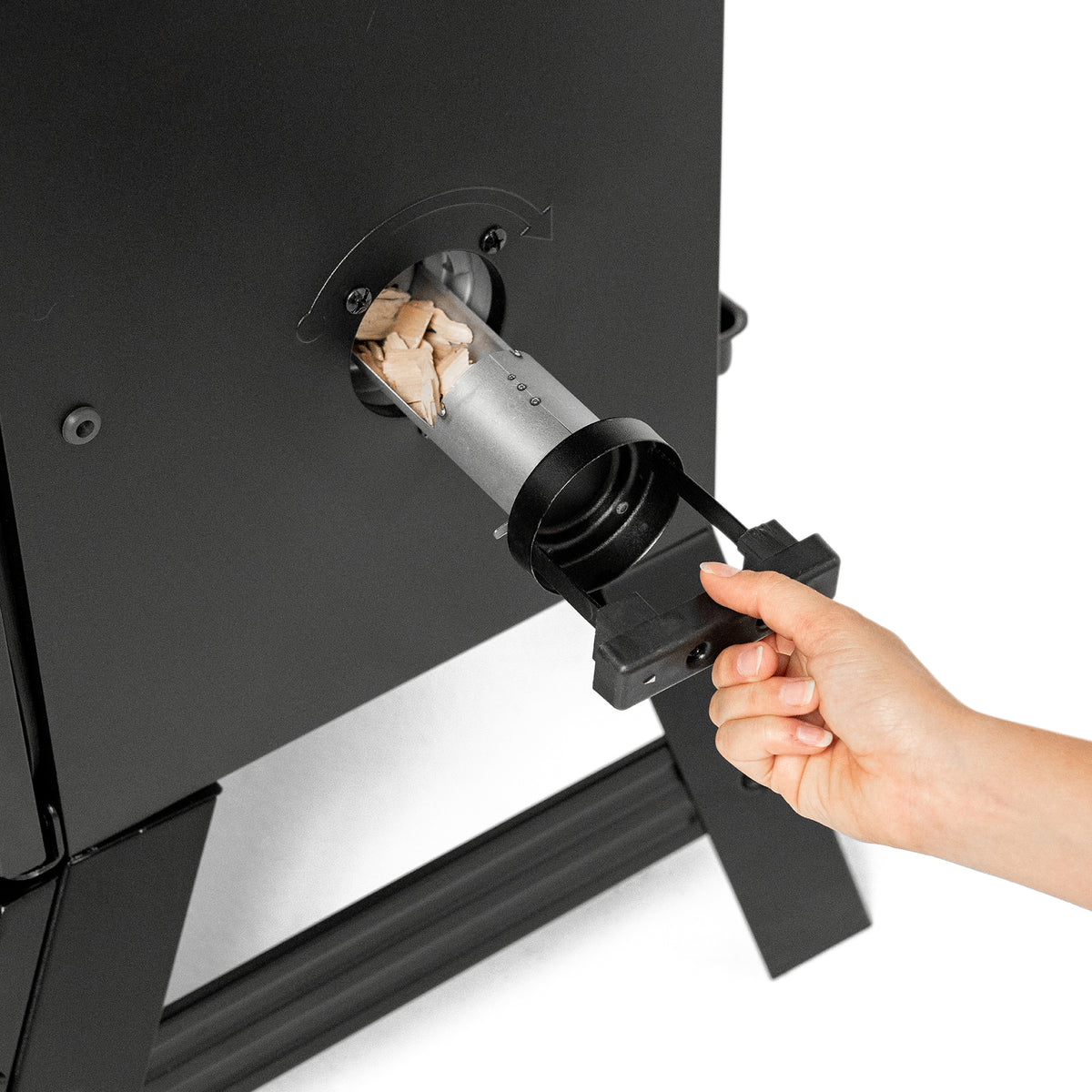 Loading wood chips into the side loader of the Masterbuilt 710 WiFi smoker