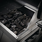 Charcoal tray filled with unlit charcoal in the Napoleon Professional 605