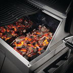 Glowing charcoal in the tray of the Napoleon Professional 605