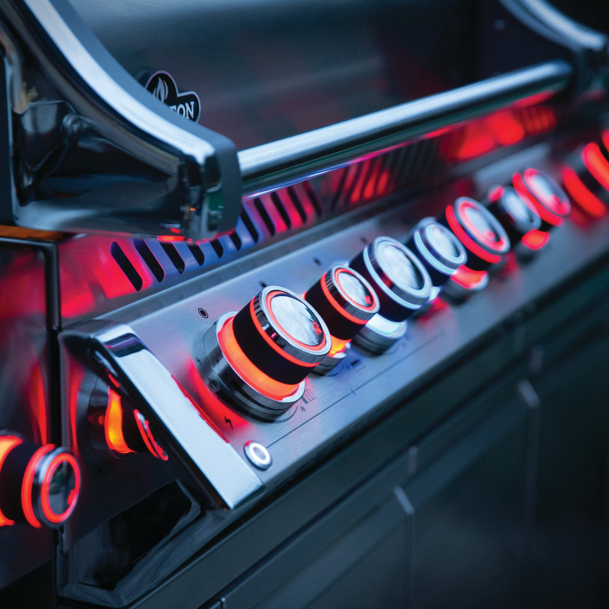 Napoleon Prestige PRO 825 control knobs glowing red at dusk