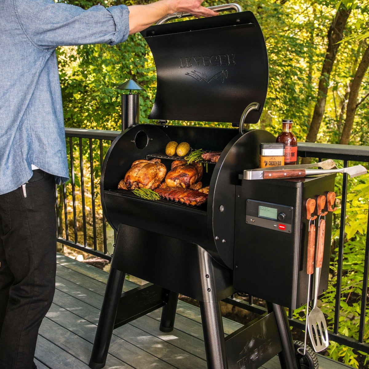 Man cooking on the Traeger Pro 575 on a balcony