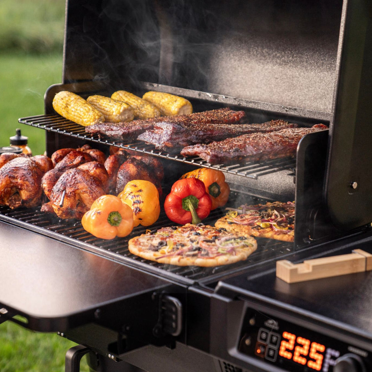 Chicken, vegetables and pizza cooking on the Traeger Woodridge