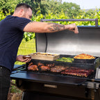 Man cooking on the Traeger Ironwood XL outdoors