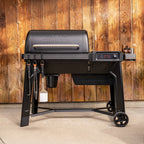 Traeger Woodridge wood pellet grill on a patio with accessories