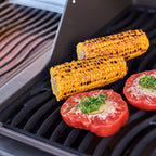 Corn on the cob and stuffed tomatoes grilling on the Napoleon Rogue PRO 425 SIB