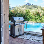 Napoleon Rogue PRO-S 525 Gas BBQ beside a swimming pool with hills behind